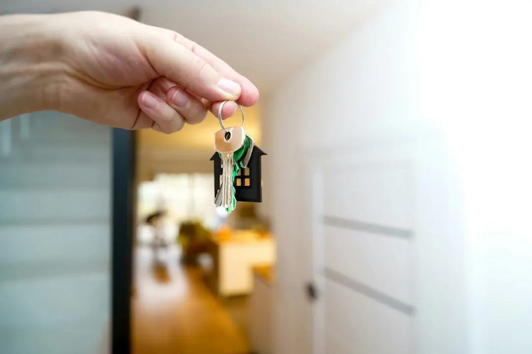 Hand holding door keys in a new home, representing the final handover of an Egyptian property